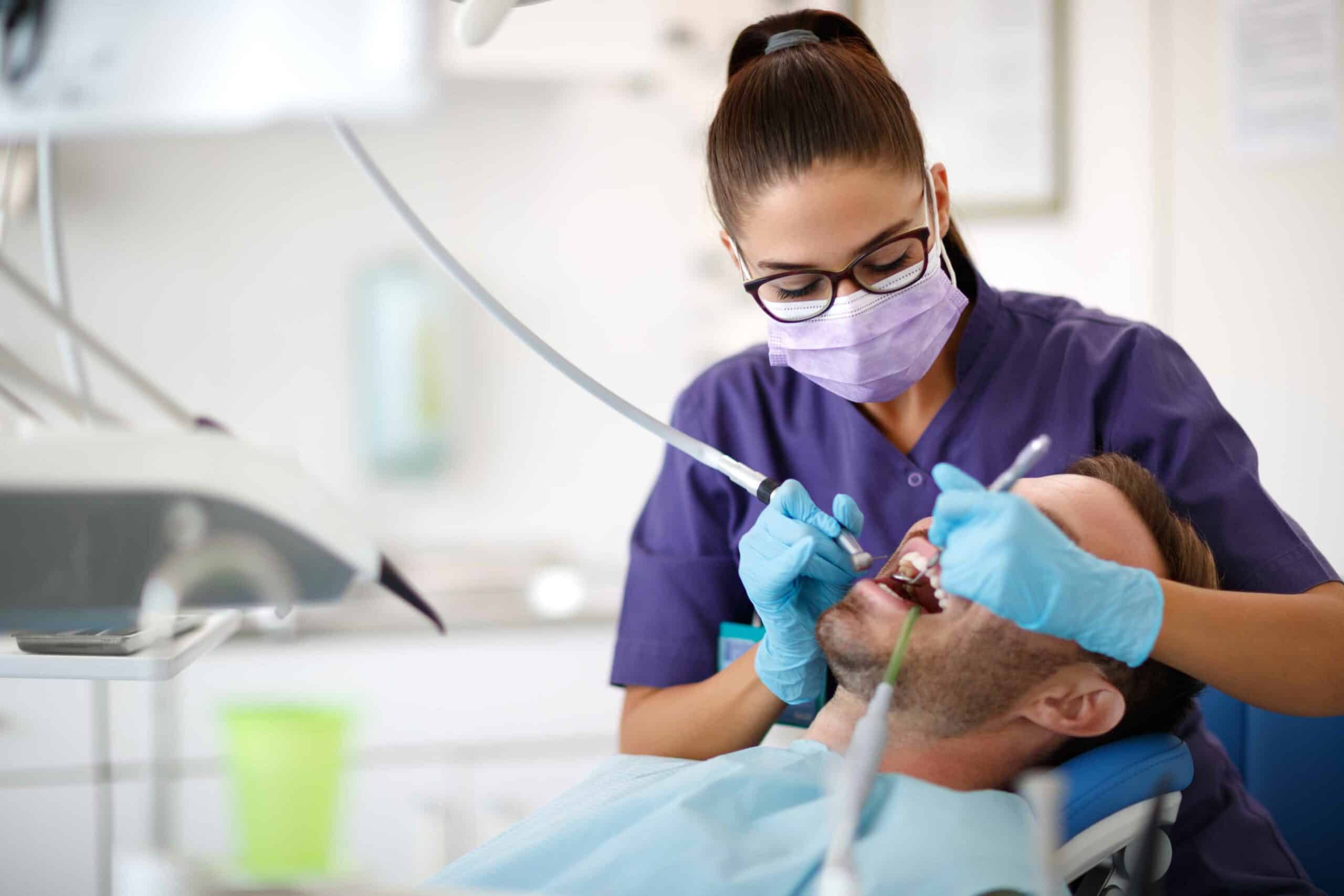 Dentist Giving Dental Treatment to Man | Solomon Family Dentistry in Summerville & Mount Pleasant, SC