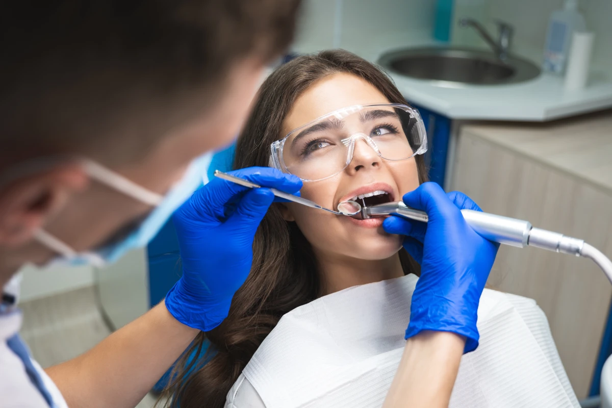 Dentist performing root canal treatment for persistent tooth pain and infected tooth relief during a dental procedure.